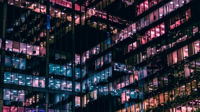 Urban Nightscape: Multicolored Lights Reflecting Off Windows